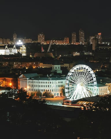 Illuminated ferris wheel at night