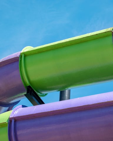 Colorful tube water slides against a blue sky