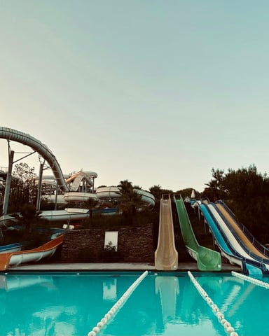 Water park with multiple slides and a large pool