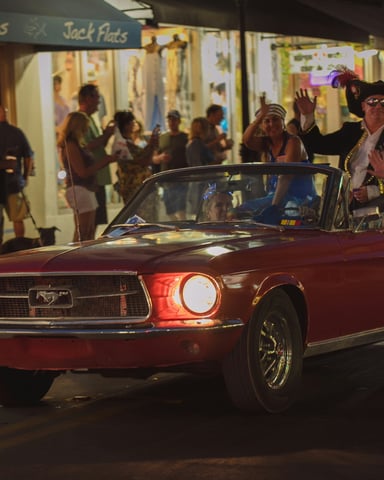 Classic car cruising through Old Town Kissimmee at night